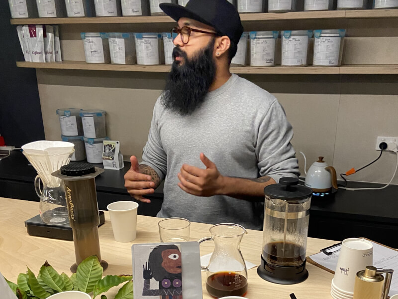 A man surrounded by manually brewed coffee