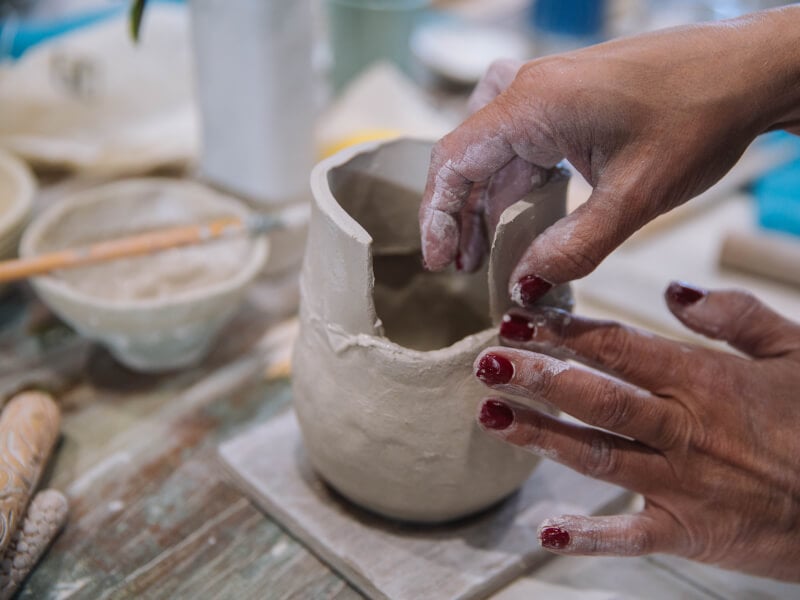 Hands building clay