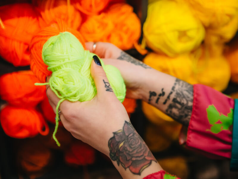 hand holding colourful yarn