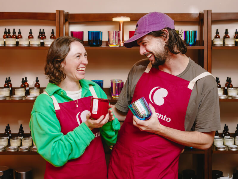 A couple pose with their handmade candle gifts