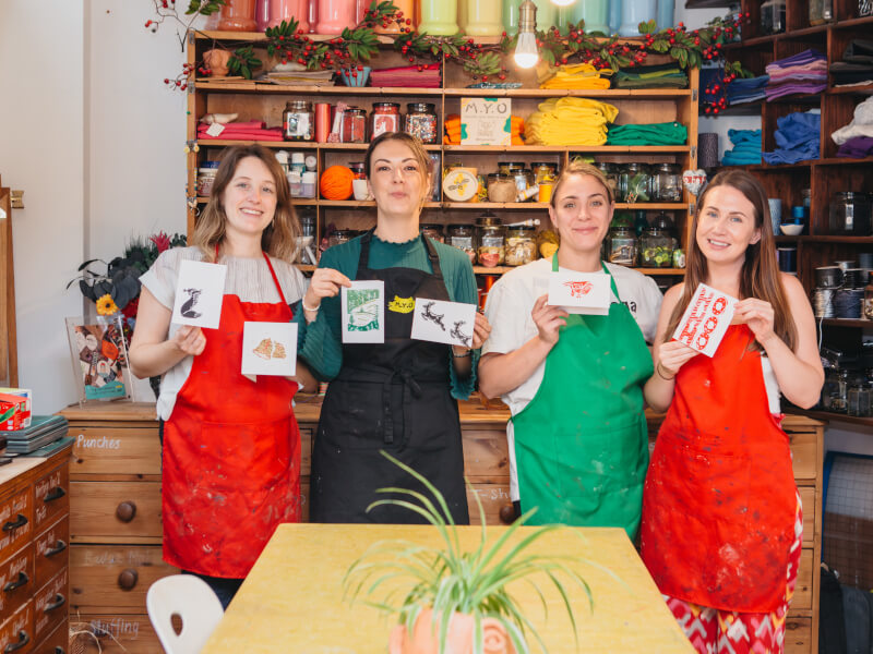 A group of friends show their handmade xmas cards