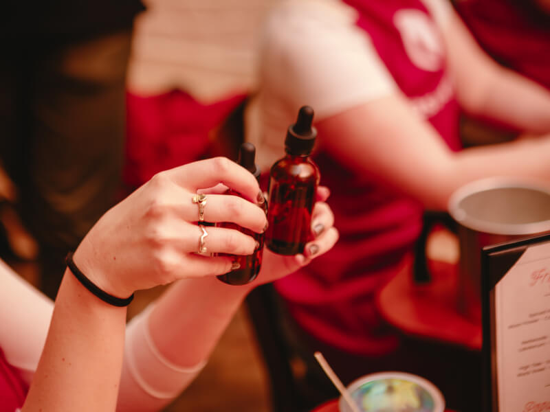 Close up of hands holding an essential oil bottle