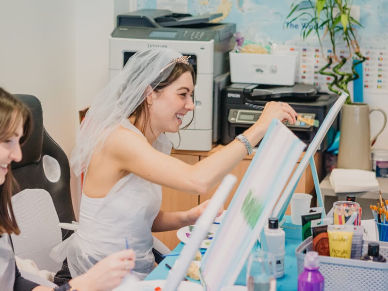 Bride-to-be painting a canvas 