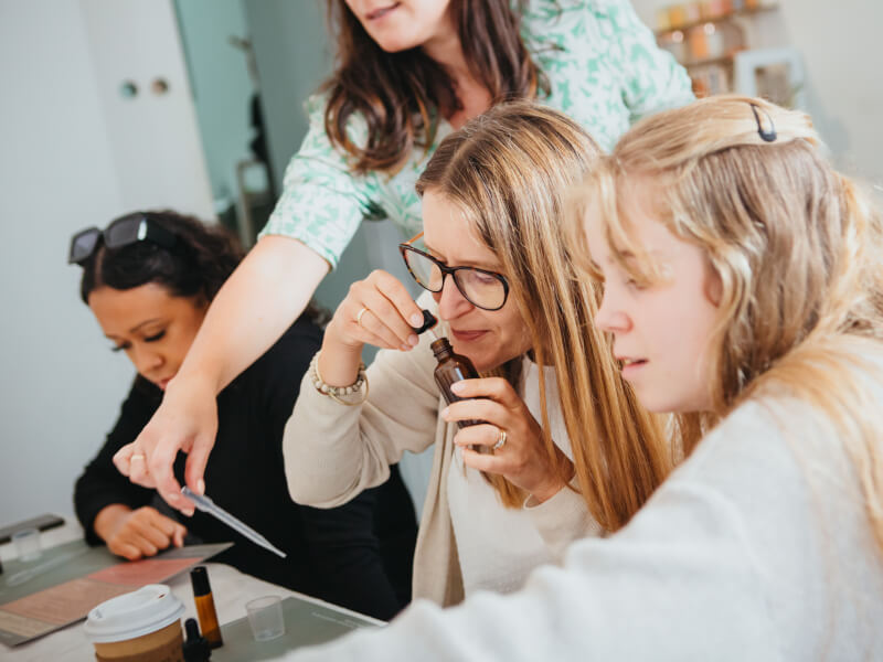Group of women sniffing essential oils at fragrance class