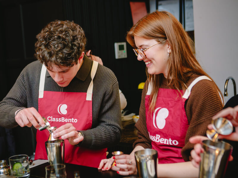 A husband and wife make cocktails together