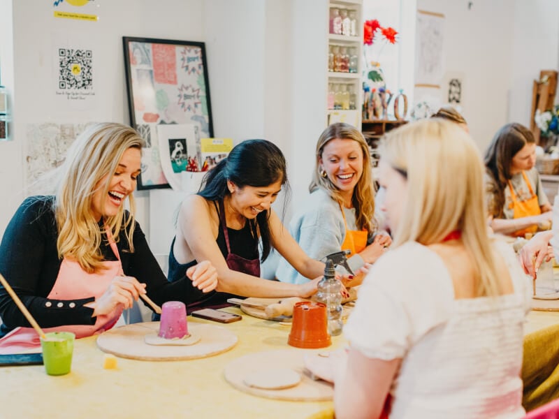 Women enjoying a hens party at a pottery class