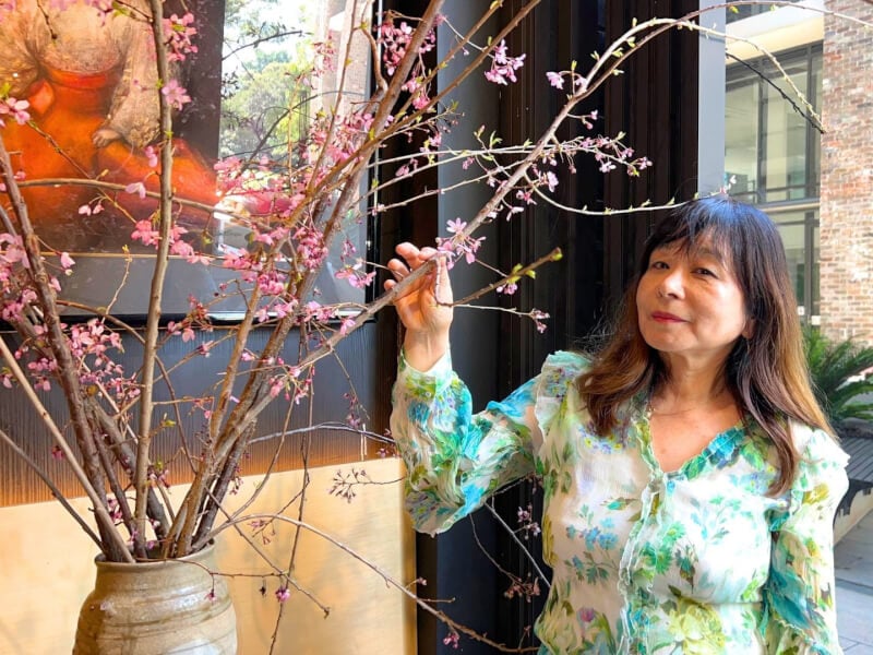 A woman showcases her finished Ikebana
