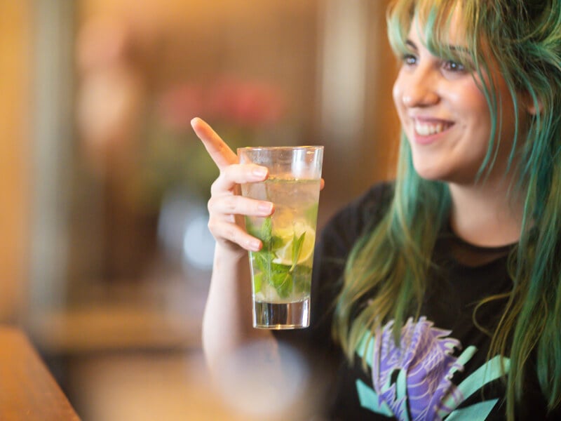 Woman smiling with mojito cocktail