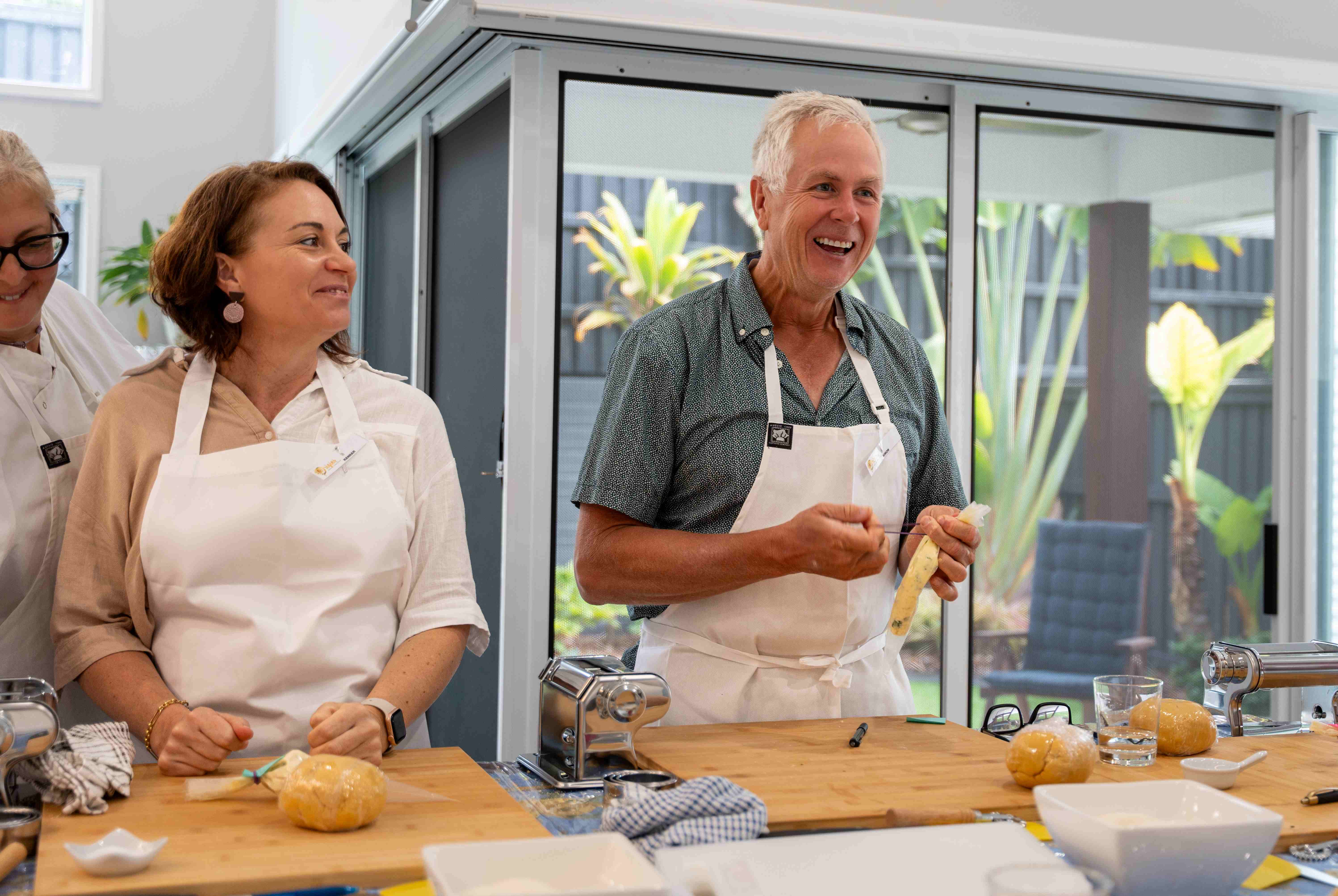 People enjoying a pasta making class