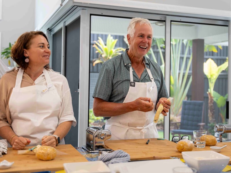 Two people making pasta together