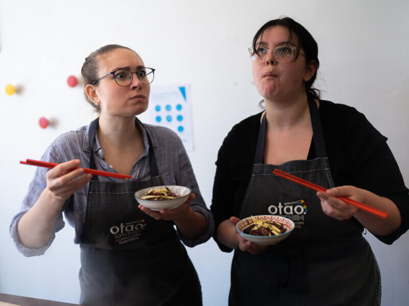 Two women enjoying the Japanese food they made at cooking class in Melbourne