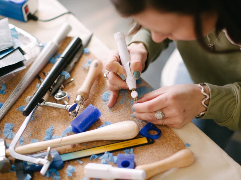 A woman making jewellery at home