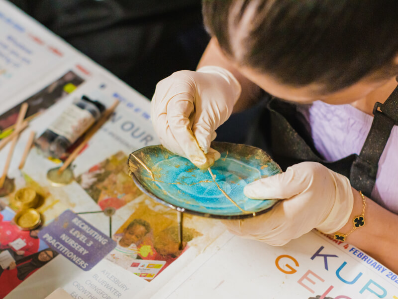 A woman focusing on the art of kintsugi