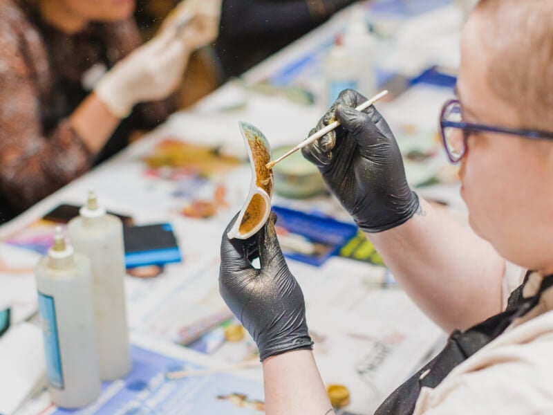 A person making kintsugi