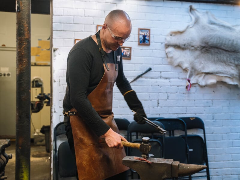 A man enjoying a knife making class for his birthday