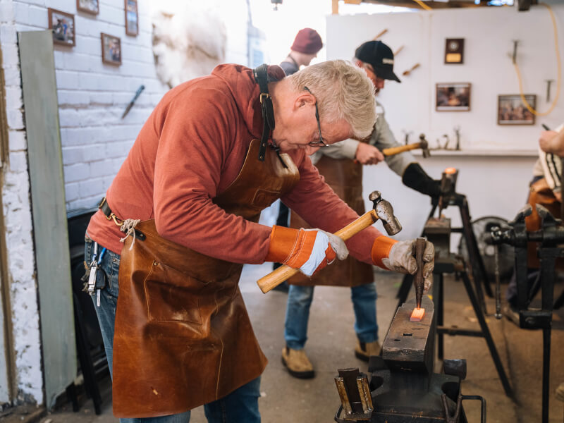 A man enjoys knife making
