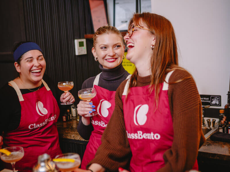 A group of girlfriends drink cocktails for a birthday