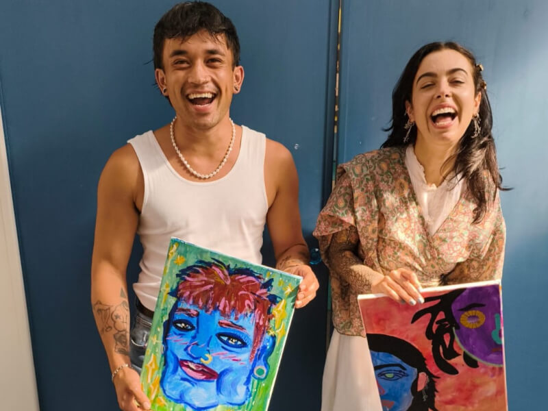 A laughing couple at a paint your partner class