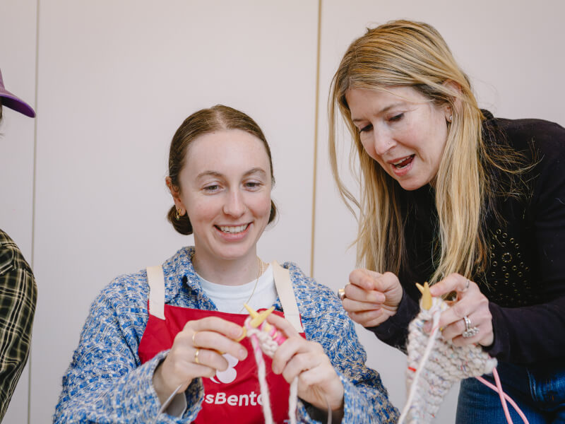 A woman learns to knit at a textile class