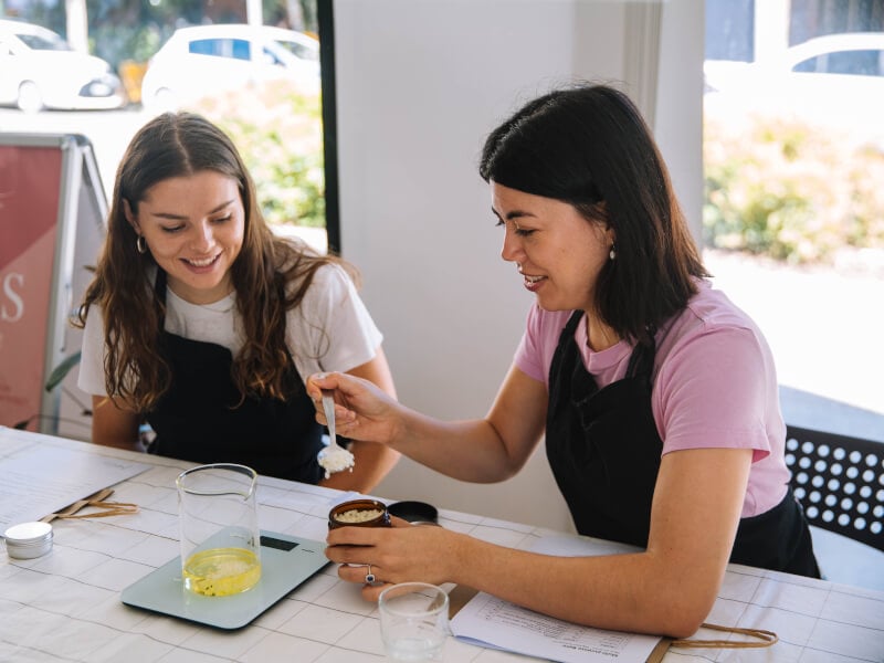 Two women enjoying a perfume making class experience gift