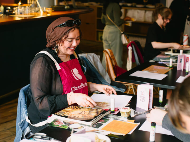 A woman smiling as she makes a vision board