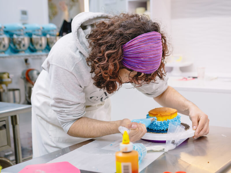 A son baking a cake for his dad