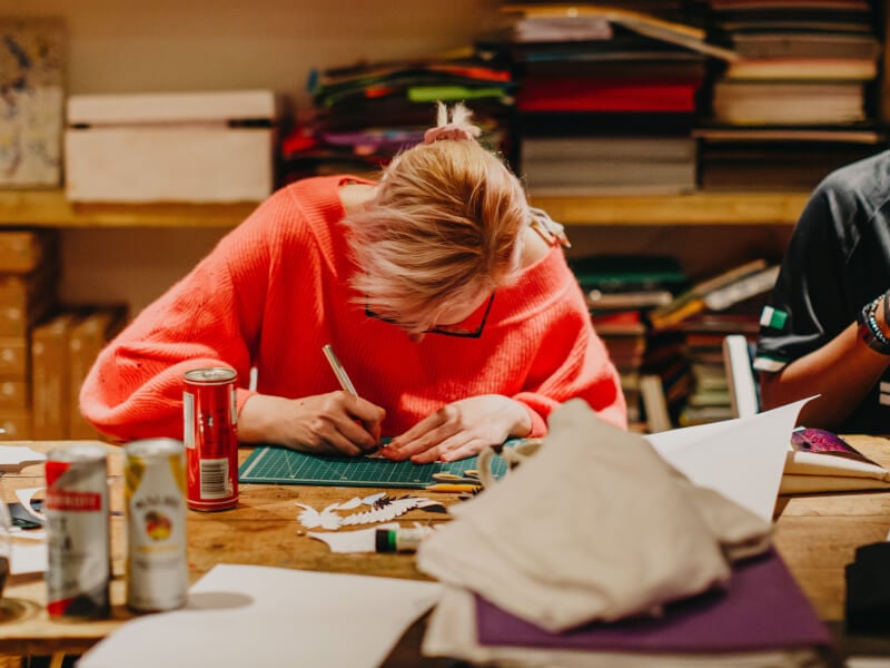 A woman immersed in notebook making