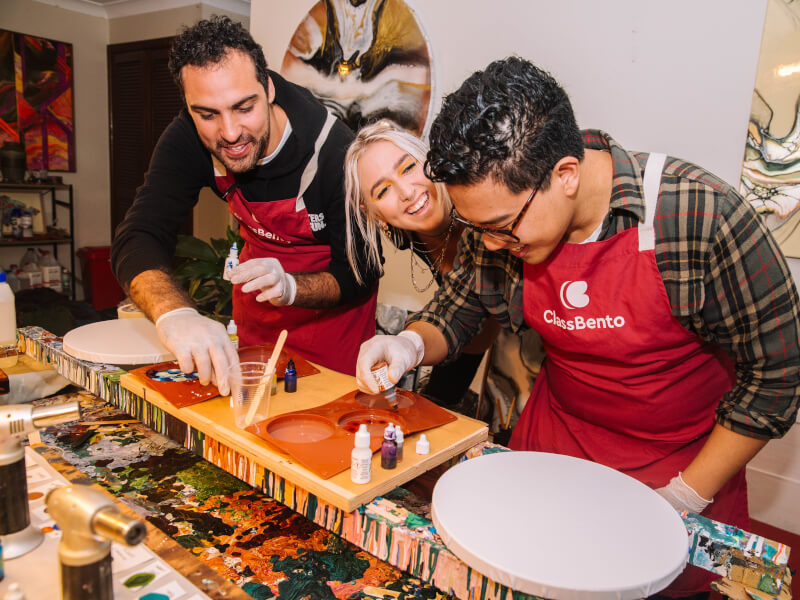 A man enjoying the resin art class he was gifted for his anniversary present