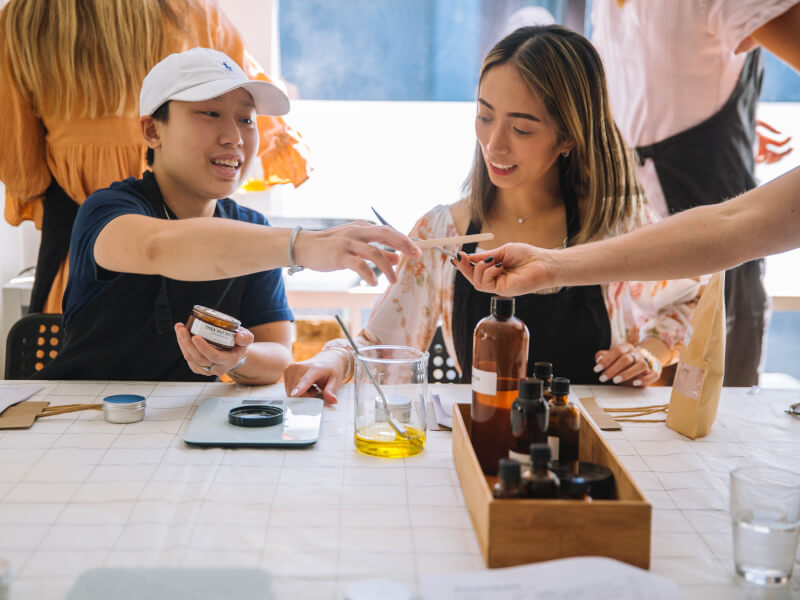 A man and a woman making beauty products together