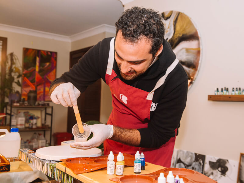 Man creating art at fluid art class