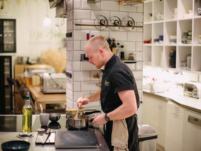 A man enjoys a cooking class in a pristine kitchen