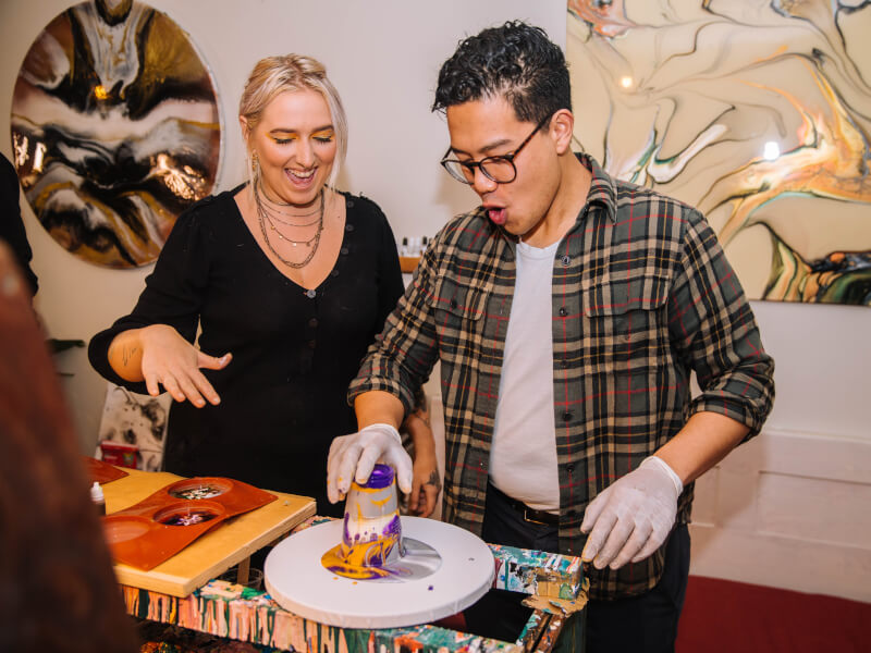 A man having fun at a fluid art class