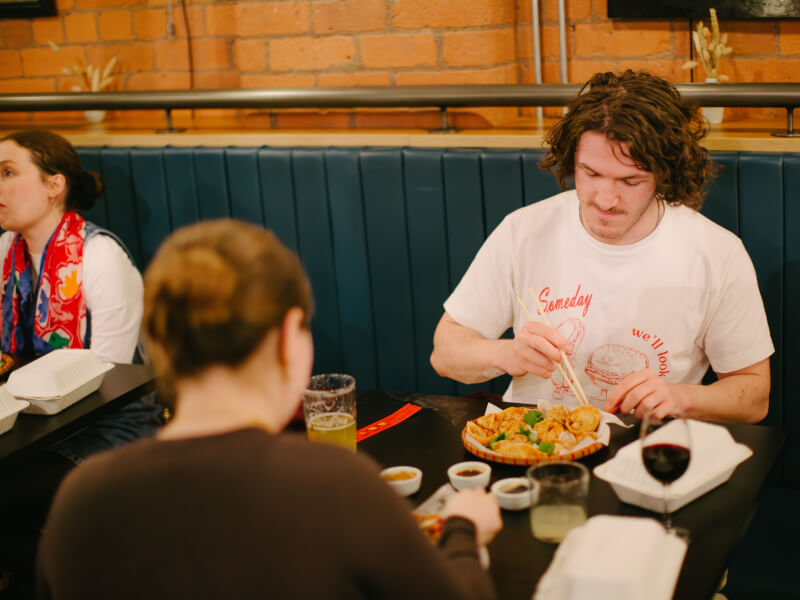 Man eats dumplings he made at a cooking class