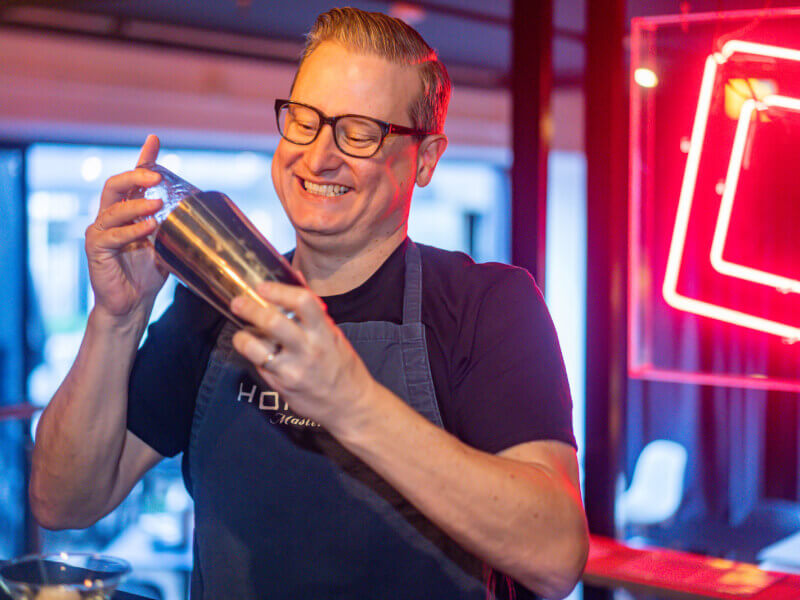 A man shaking cocktails