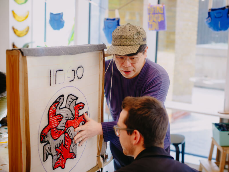 A man tufting his own rug