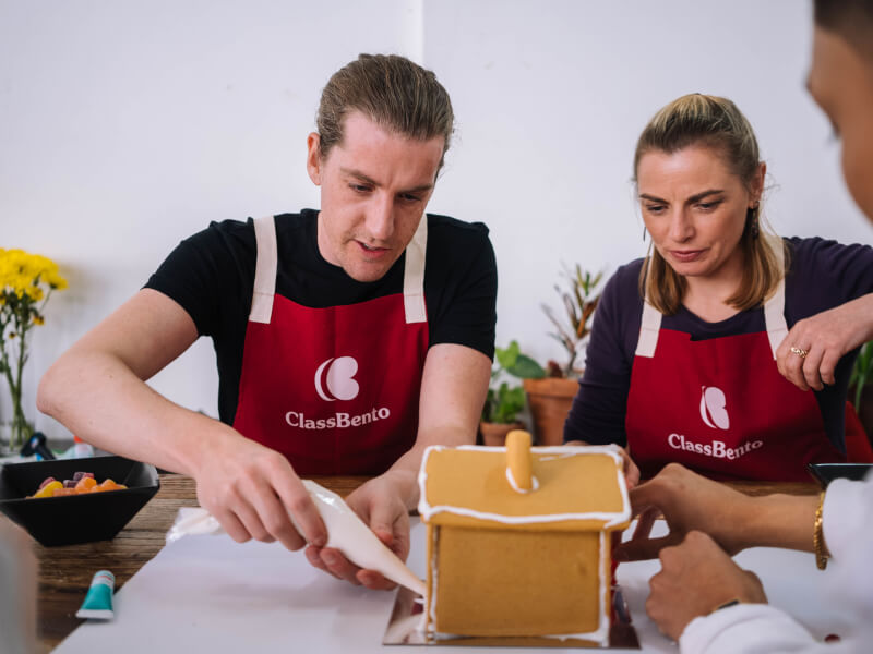A couple having fun at a gingerbread making workshop