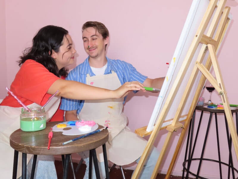 A paint covered couple enjoy a fun paint and sip in Perth