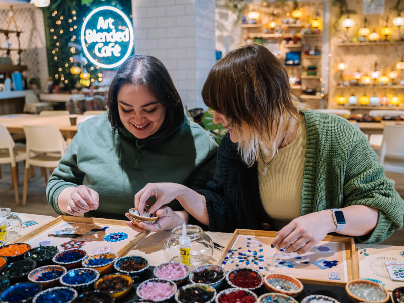 A couple on a date night at a mosaic class