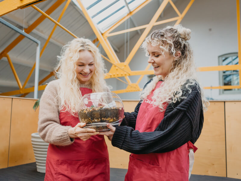Mother and daughter holding a terrarium