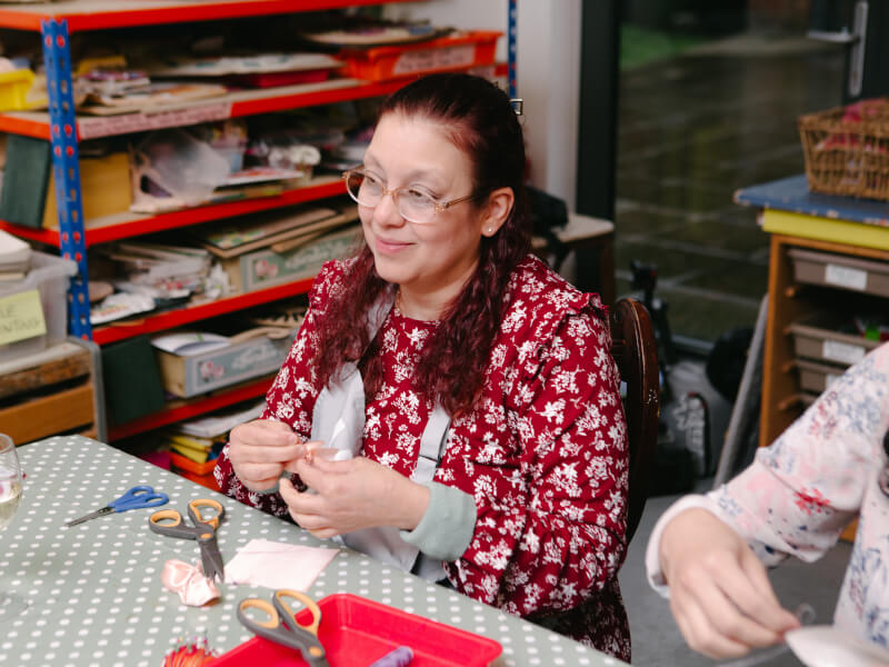 Woman smiling at a craft class