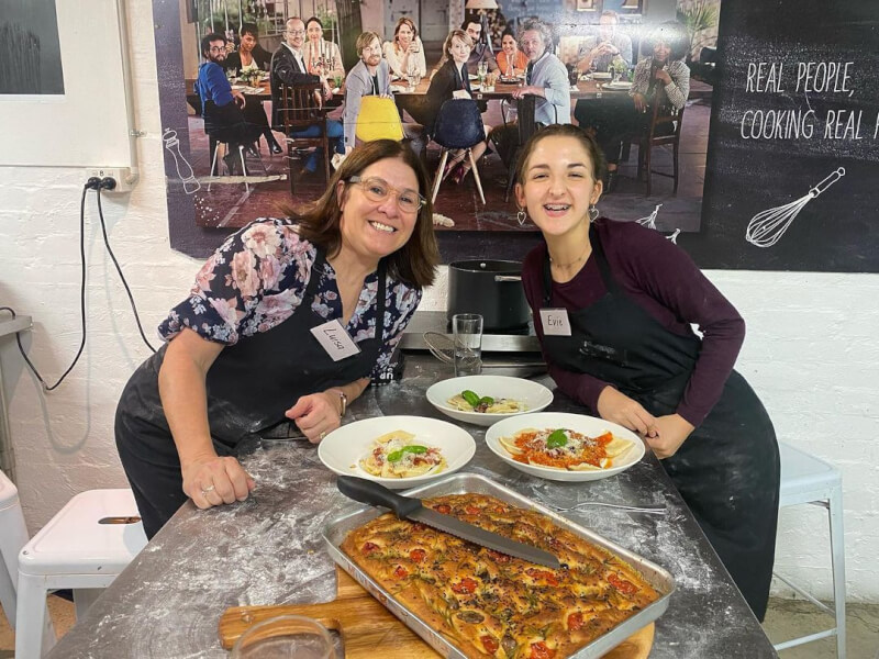 Mother and daughter showing their handmade focaccia