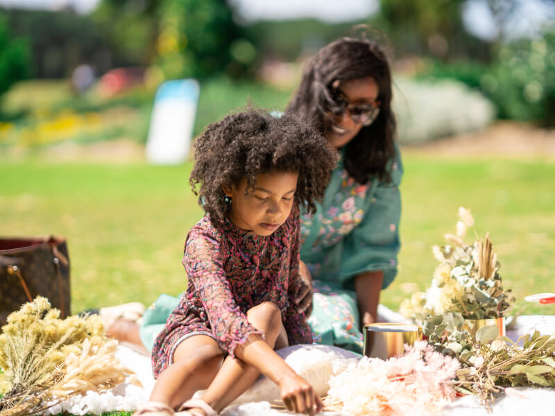 Mother and daughter enjoying an outdoor flower arranging class