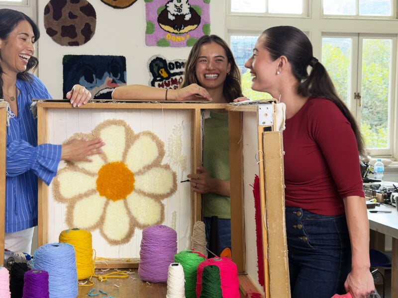 A mother and her two daughters do punch needle