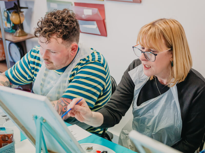 Mother and son enjoying a mothers day paint and sip class
