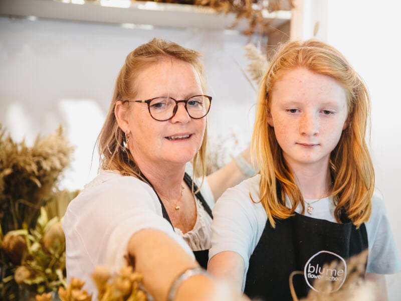 Mother and young daughter selecting flowers at a Mothers Day floristry class