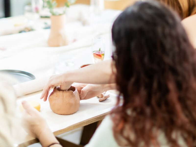 A woman hand building a mug