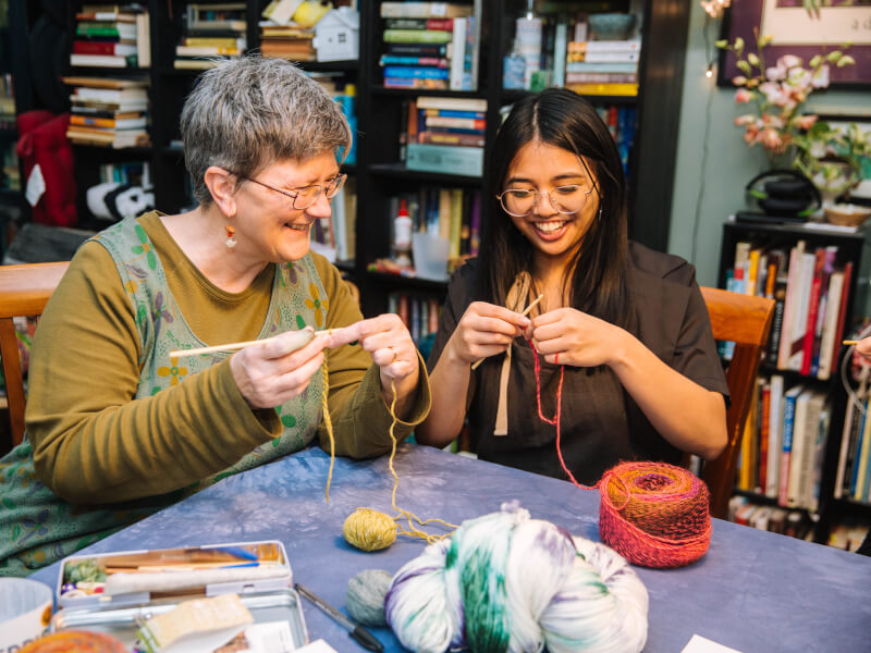 Grandmother and daughter learning to knit at a knitting class in Brisbane