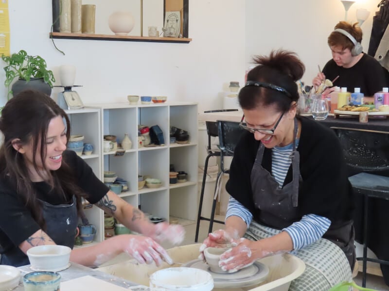 A mother and daughter do a wheel throwing class together