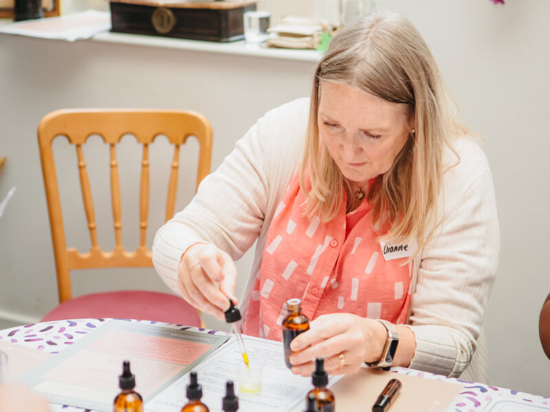 Woman working with essential oils at perfume making class