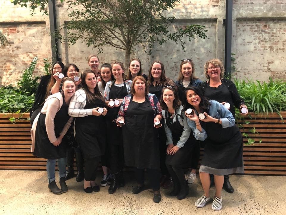 Large group of women celebrating a hens party with a skincare workshop